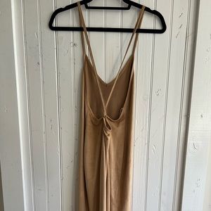Midi body-con dress. Straps crisscross in the back. Tan color. Suede texture.